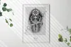 A framed picture is displayed on a white wall, with shadows cast by blinds and some greenery on the sides. Produktbild-Vorschau