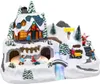 A festive Christmas village scene with a house, Santa, children playing in the snow, a tractor, and a waterfall. Náhľad obrázku produktu