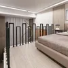 A bedroom with a railing in the foreground and a bed in the background. Náhled obrázku produktu