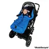 A baby is sitting in a stroller, wrapped in a blue sleeping bag. Produktbild-Vorschau