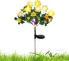 A solar-powered decorative flower light with yellow flowers and green leaves, planted in grass. Náhled obrázku produktu