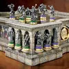 A detailed view of a Lord of the Rings themed chess set, showcasing intricate detailing on the board and pieces. Podgląd zdjęcia produktu