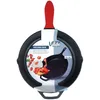 A black cast iron frying pan with a red silicone handle grip, presented in its packaging with product information and an image of food. Produktbild-Vorschau