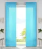 Two turquoise panel curtains are shown hanging in front of a window with a view of trees and sky. Produktbild-Vorschau