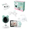 A flat lay of a baby monitor set, including the camera, parent unit, power adapters, cables, and packaging. Náhľad obrázku produktu
