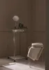 A bathroom scene with a glass shelf unit and towels. Anteprima dell’immagine prodotto