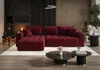 A modern living room with a large red sectional sofa, coffee tables, and a fireplace. Produktbild-Vorschau