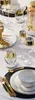A table setting with wine glasses, plates, and cutlery. Podgląd zdjęcia produktu