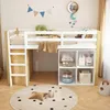 A child's loft bed with storage underneath, set up in a bedroom. Voir les images du produit