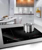 A modern kitchen with an induction cooktop and a pot on it. Voir les images du produit