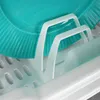 Close-up of a turquoise plate resting in a white dish drying rack. Produktbild-Vorschau