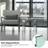 A modern living room setting with a glass side table and a chair. Produktbild-Vorschau
