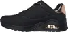 A side view of a black Skechers sneaker with rose gold accents. Voir les images du produit