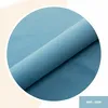 A close-up of a rolled piece of blue fabric, presented within a circular frame against a soft background. Anteprima dell’immagine prodotto