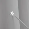 A close-up of a star-shaped cutout on a gray surface with a gray cord extending from it. Produktbild-Vorschau