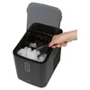 A hand is scooping ice from a black ice maker. Anteprima dell’immagine prodotto