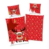 A collection of Christmas-themed bedding items, including pillowcases and a duvet cover, featuring a red background with white snowflakes and cartoon reindeer illustrations. Produktbild-Vorschau