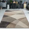 A modern living room or office space with a geometric rug in the foreground and a desk area in the background. Produktbild-Vorschau
