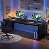 A modern gaming setup featuring a long desk with two monitors, gaming peripherals, and a computer tower, illuminated by ambient blue and pink lighting. Produktbild-Vorschau