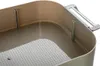 Close-up view of the interior of a beige plastic party box with a perforated insert. Voir les images du produit
