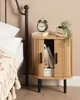 A bedside table with books and a plant next to a bed. Náhľad obrázku produktu