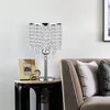 A crystal table lamp sits on a side table next to a couch. Produktbild-Vorschau