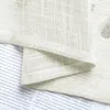 A close-up of a textured, sheer fabric, likely a curtain or textile, with text visible underneath. Anteprima dell’immagine prodotto