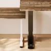 A close-up view of the legs of two desks, one white and one black, with wooden tabletops. Anteprima dell’immagine prodotto