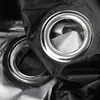 A close-up shot of two metal grommets on black and silver fabric. Produktbild-Vorschau