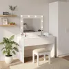 A white vanity table with a lighted mirror, a stool, and a plant in a pot. Náhled obrázku produktu