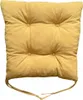 A yellow tufted seat cushion with ties. Produktbild-Vorschau