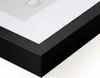 Close-up view of the corner of a black picture frame with a white mat. Produktbild-Vorschau