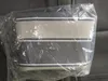 A product is shown inside a clear plastic bag, lying on a dark surface. Produktbild-Vorschau