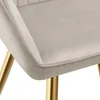 A close-up view of a beige velvet-look chair with gold legs. Produktbild-Vorschau