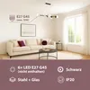 A modern living room with a sofa, coffee table, and a large window, featuring a pendant light. Produktbild-Vorschau