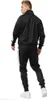 A man wearing a black tracksuit with white stripes on the sides, shown from the back. Anteprima dell’immagine prodotto
