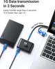 A black USB hub is connected to a laptop and an external hard drive, with blue light effects indicating data transfer. Náhľad obrázku produktu