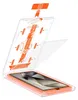 A clear plastic installation guide for a screen protector is shown open, with the screen protector partially lifted. Produktbild-Vorschau
