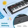 A black electronic keyboard with a microphone, shown with decorative elements like a sun and balloons, and close-up views of its ports and text labels. Náhled obrázku produktu