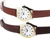 Two watches with brown leather straps and white faces with gold bezels are shown side-by-side. Produktbild-Vorschau
