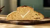 A slice of bread on a wooden cutting board. Náhled obrázku produktu