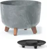 A planter pot with a concrete-like finish and wooden legs, shown with a separate drain cover. Náhled obrázku produktu