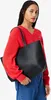 A woman is holding a black tote bag. Anteprima dell’immagine prodotto