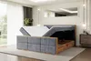 A bedroom scene featuring a bed with its storage compartment open. Produktbild-Vorschau