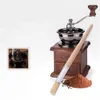 A vintage coffee grinder with a cleaning brush and ground coffee. Produktbild-Vorschau