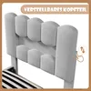 Close-up of a grey upholstered bed headboard with adjustable feature indicated by an icon. Náhled obrázku produktu