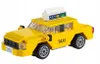 A yellow toy taxi made of building blocks, shown from a 3/4 front-side angle against a white background. Podgląd zdjęcia produktu