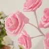 Close-up of several artificial pink roses on stems. Produktbild-Vorschau