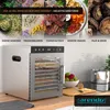 A silver Arendo dehydrator is shown on a kitchen counter, surrounded by various dried food items and ingredients, with promotional text overlaying the top portion of the image. Náhľad obrázku produktu