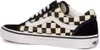 A side view of a Vans Old Skool sneaker with a black and beige checkerboard pattern. Voir les images du produit